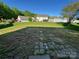 Overlooking a spacious backyard with a lush lawn, with several homes nearby at 2815 Cartesian Dr, Charlotte, NC 28214