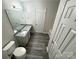 Full bathroom with gray wood-look flooring, granite counters and single vanity at 2815 Cartesian Dr, Charlotte, NC 28214