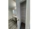Bright bathroom showcasing vinyl flooring, granite countertops, and an open storage closet at 2815 Cartesian Dr, Charlotte, NC 28214