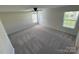 Spacious bedroom with carpeted floors, a ceiling fan, and multiple windows with blinds at 2815 Cartesian Dr, Charlotte, NC 28214