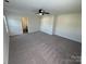 Spacious bedroom featuring a ceiling fan, neutral paint and soft carpeting at 2815 Cartesian Dr, Charlotte, NC 28214
