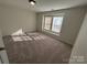 Carpeted bedroom filled with natural light from the window with blinds at 2815 Cartesian Dr, Charlotte, NC 28214