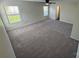 Large bedroom featuring two windows, neutral paint and soft carpeting at 2815 Cartesian Dr, Charlotte, NC 28214