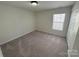 Bedroom features carpeted floors, a window with blinds, a ceiling light, and a closet at 2815 Cartesian Dr, Charlotte, NC 28214