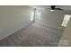 Bright bedroom featuring three windows, neutral paint and soft carpeting at 2815 Cartesian Dr, Charlotte, NC 28214