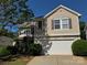 Inviting two-story home showcasing neutral siding, a white garage door, and well-maintained landscaping at 2815 Cartesian Dr, Charlotte, NC 28214