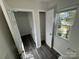 Hallway featuring vinyl plank flooring, a storage closet, and a bright window at 2815 Cartesian Dr, Charlotte, NC 28214