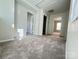 Hallway with neutral walls and carpet leads to sunlit rooms, offering a welcoming feel at 2815 Cartesian Dr, Charlotte, NC 28214