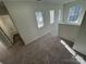 Upstairs hallway with carpet, multiple windows with blinds, and access to the bathroom at 2815 Cartesian Dr, Charlotte, NC 28214