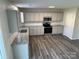Spacious kitchen featuring stainless steel appliances, gray cabinets, and granite countertops at 2815 Cartesian Dr, Charlotte, NC 28214