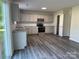 Updated kitchen with gray cabinets, stainless steel appliances, and a sliding glass door to the yard at 2815 Cartesian Dr, Charlotte, NC 28214