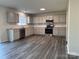 Bright kitchen showcasing stainless steel appliances, granite countertops, and gray cabinets at 2815 Cartesian Dr, Charlotte, NC 28214