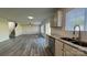 Open concept living room with wood-look flooring and a view of the kitchen and backyard at 2815 Cartesian Dr, Charlotte, NC 28214