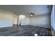 Open-concept living room featuring wood-look flooring, a ceiling fan, and a staircase at 2815 Cartesian Dr, Charlotte, NC 28214