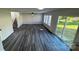Spacious living room with wood-look flooring, stairs, backyard view through a sliding door at 2815 Cartesian Dr, Charlotte, NC 28214