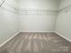 Spacious walk-in closet featuring soft carpet and wire shelving at 2815 Cartesian Dr, Charlotte, NC 28214