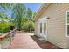 Spacious wooden back deck with railing, double doors, and view of the lush backyard at 2942 Denwood Dr, Claremont, NC 28610