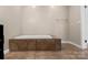 Bathroom featuring a large, tiled soaking tub with neutral walls and flooring at 2942 Denwood Dr, Claremont, NC 28610