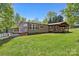 View of the house's covered deck and the yard behind the home at 2942 Denwood Dr, Claremont, NC 28610