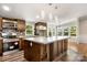 Spacious kitchen showcases stainless appliances, a large island, and backyard views at 2942 Denwood Dr, Claremont, NC 28610