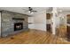 Inviting living room features a stone fireplace, built-in shelving and gleaming hardwood floors at 2942 Denwood Dr, Claremont, NC 28610