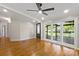 Open living room features hardwood floors, a ceiling fan, and large windows at 2942 Denwood Dr, Claremont, NC 28610