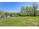 Expansive backyard with lush lawn and green trees at 2942 Denwood Dr, Claremont, NC 28610