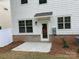 A cozy backyard featuring a concrete patio and door, perfect for outdoor relaxation and entertaining at 3019 Glenn Hope Way, Matthews, NC 28104