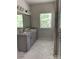 Bright bathroom featuring double sinks, a large window, and a glass-enclosed shower with marble-style tiling at 3019 Glenn Hope Way, Matthews, NC 28104