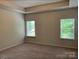 Spacious carpeted bedroom with two windows providing natural light at 3019 Glenn Hope Way, Matthews, NC 28104