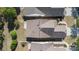 An aerial view of a home's roof, landscaping, and driveway, showing its layout in a well-maintained neighborhood at 3040 Azalea Dr, Indian Land, SC 29707