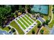 An aerial view of the community lawn bowling and tennis courts surrounded by lush trees at 3040 Azalea Dr, Indian Land, SC 29707
