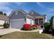 Charming home with gray shingle siding, a two-car garage, and vibrant red landscaping at 3040 Azalea Dr, Indian Land, SC 29707