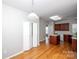 Open kitchen with wood floors, brown cabinets, and a center island perfect for cooking and entertaining at 3040 Azalea Dr, Indian Land, SC 29707