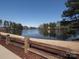Scenic community lake view showcases a peaceful atmosphere with mature trees and a walking path at 3040 Azalea Dr, Indian Land, SC 29707