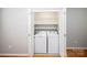 Well-lit laundry closet boasts a white washer and dryer and practical shelving for organized storage solutions at 3040 Azalea Dr, Indian Land, SC 29707