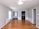 Open living room with hardwood floors, neutral paint, and views to the kitchen and foyer at 3040 Azalea Dr, Indian Land, SC 29707