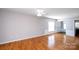 Bright living room features hardwood floors, neutral paint, and view to foyer at 3040 Azalea Dr, Indian Land, SC 29707