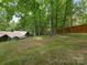 Spacious backyard with trees and partial home view at 3232 Johnny Cake Ln, Charlotte, NC 28226