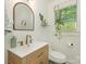 Bathroom featuring a wood vanity, bronze fixtures, and decorative mirror at 3232 Johnny Cake Ln, Charlotte, NC 28226