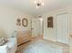 Bedroom with a changing table, rocking chair, and a view of an open doorway at 3232 Johnny Cake Ln, Charlotte, NC 28226