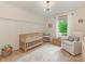 Bedroom with a wooden crib, glider, and natural light from the windows at 3232 Johnny Cake Ln, Charlotte, NC 28226