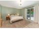 Bedroom with an accent wall, hardwood floors, and a sliding glass door to the outdoor patio at 3232 Johnny Cake Ln, Charlotte, NC 28226