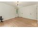 Bright, spacious bedroom with light hardwood floors and modern globe light fixture at 3232 Johnny Cake Ln, Charlotte, NC 28226