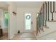 Bright foyer featuring hardwood floors, white walls and a decorative staircase at 3232 Johnny Cake Ln, Charlotte, NC 28226