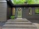 Stylish home exterior featuring a welcoming green front door and brick steps at 3232 Johnny Cake Ln, Charlotte, NC 28226