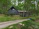 Charming home with dark exterior, lush landscaping, and a welcoming driveway at 3232 Johnny Cake Ln, Charlotte, NC 28226