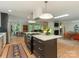 Open concept kitchen with quartz island, pendant lighting, and stainless steel appliances at 3232 Johnny Cake Ln, Charlotte, NC 28226