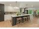 Modern kitchen with a large island, pendant lighting, and ample cabinet space at 3232 Johnny Cake Ln, Charlotte, NC 28226