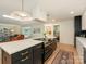 Bright kitchen with quartz countertop island and hardwood floors open to living room at 3232 Johnny Cake Ln, Charlotte, NC 28226